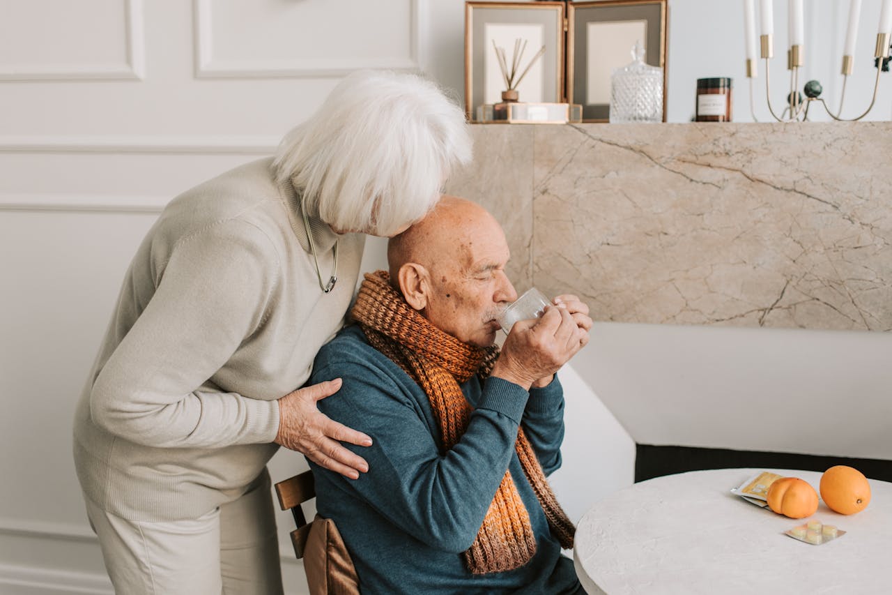 A loving elderly couple sharing a tender moment in their cozy home setting.